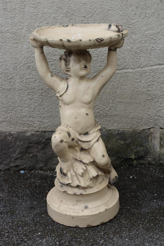 A LEFCO WARE (LEEDS FIRECLAY CO.) FIGURAL BIRDBATH modelled as a putto holding aloft a shallow oval Image