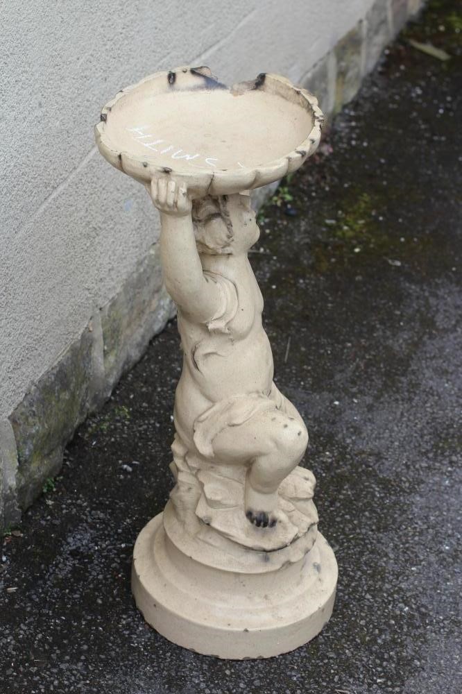 A LEFCO WARE (LEEDS FIRECLAY CO.) FIGURAL BIRDBATH modelled as a putto holding aloft a shallow oval Image