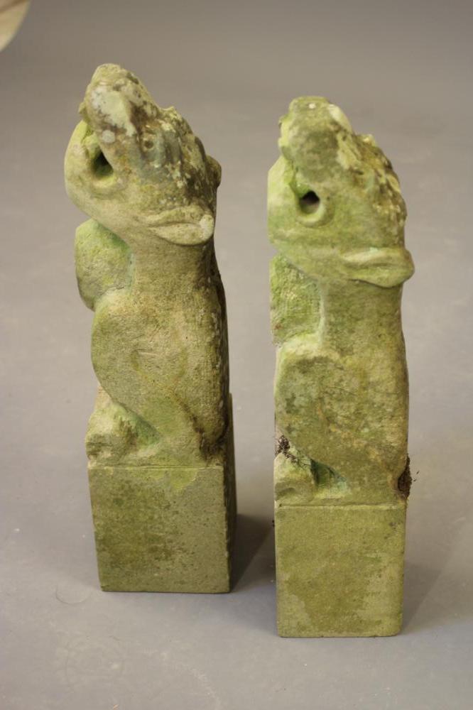 A PAIR OF CARVED SANDSTONE LION GARGOYLES on square bases Image