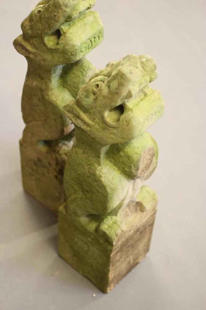 A PAIR OF CARVED SANDSTONE LION GARGOYLES on square bases Image
