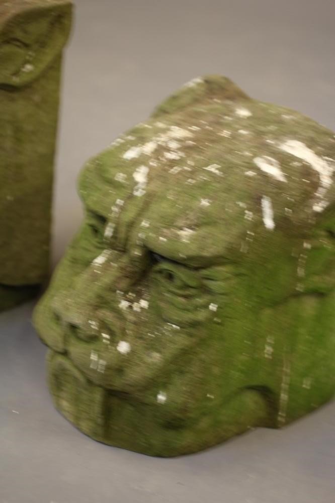 A PAIR OF CARVED STONE DOG HEAD FINIALS on square bases Image