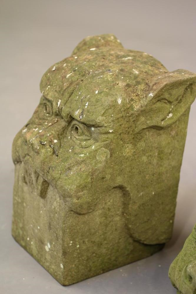 A PAIR OF CARVED STONE DOG HEAD FINIALS on square bases Image