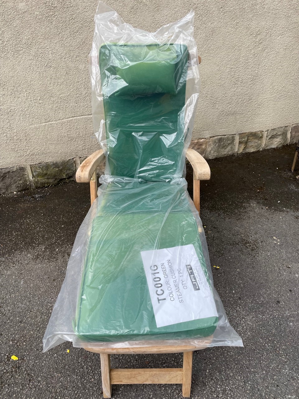 A SLATTED TEAK SUN LOUNGER ON WHEELS, with cushions Image