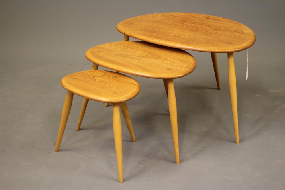 A NEST OF THREE ERCOL "PEBBLE" TABLES in light elm and beech Image