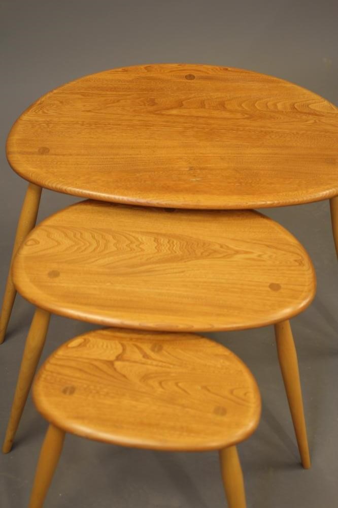 A NEST OF THREE ERCOL "PEBBLE" TABLES in light elm and beech Image