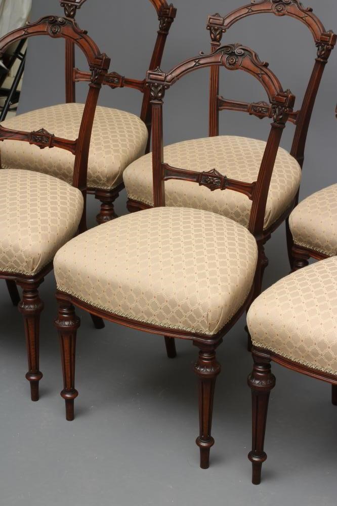 A SET OF SIX VICTORIAN WALNUT DINING CHAIRS upholstered in a cream and rust weave Image