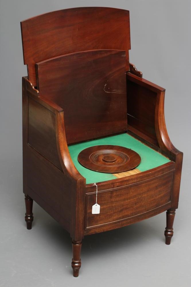 A regency mahogany "lancashire" commode of bowed form with hinged galleried top on shaped