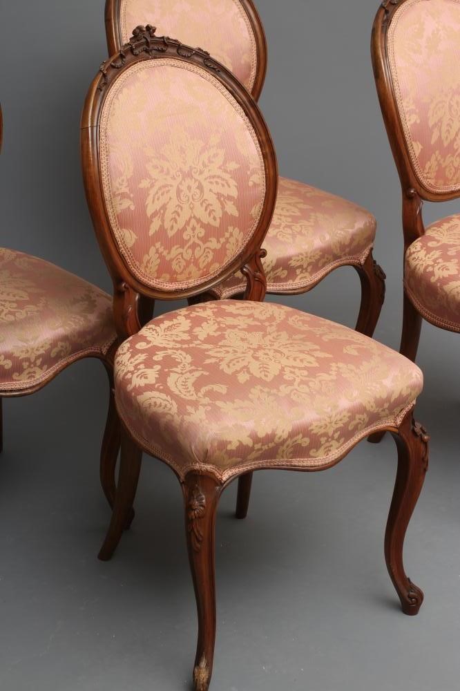 A SET OF FOUR EARLY VICTORIAN WALNUT DINING CHAIRS upholstered in pale pink silk damask Image