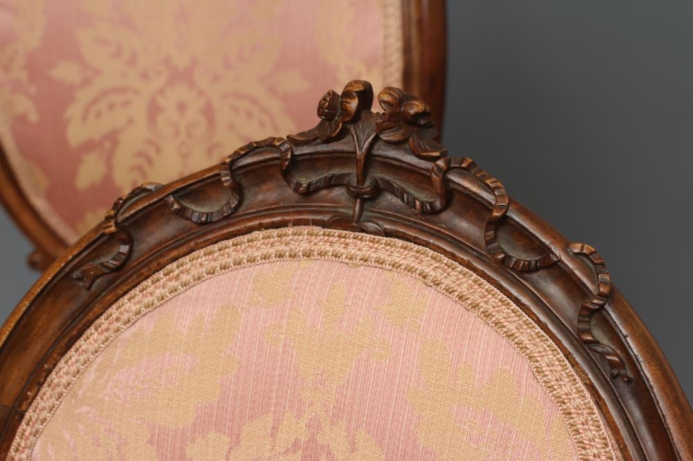 A SET OF FOUR EARLY VICTORIAN WALNUT DINING CHAIRS upholstered in pale pink silk damask Image
