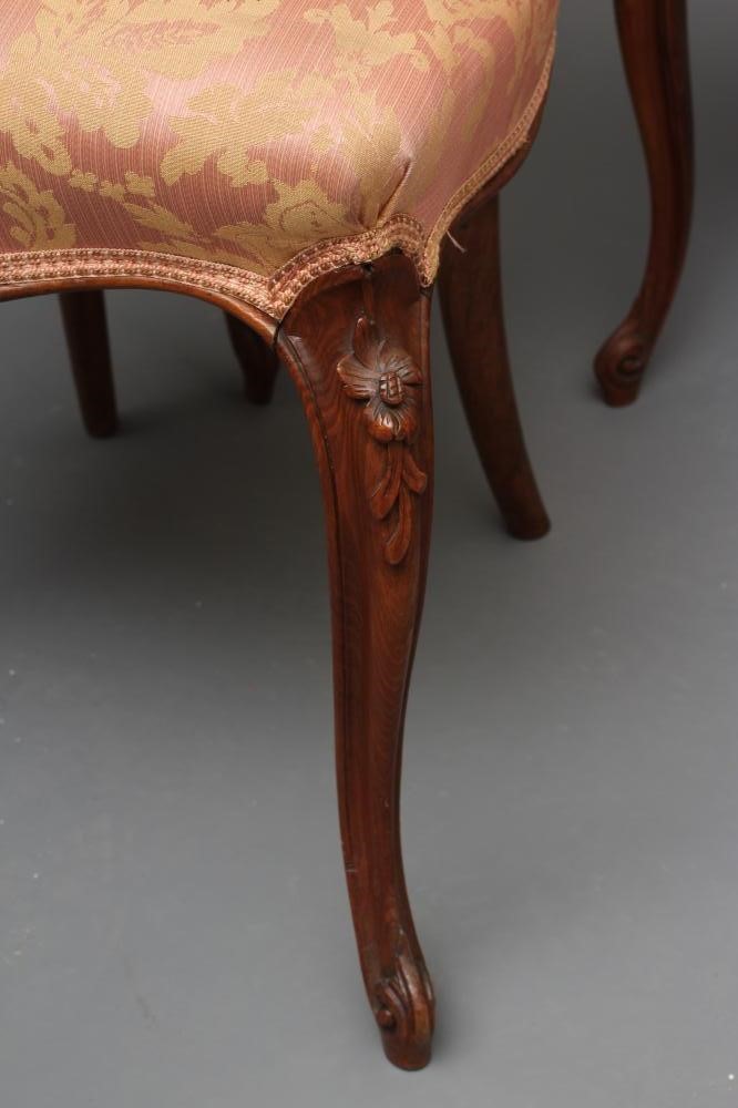 A SET OF FOUR EARLY VICTORIAN WALNUT DINING CHAIRS upholstered in pale pink silk damask Image