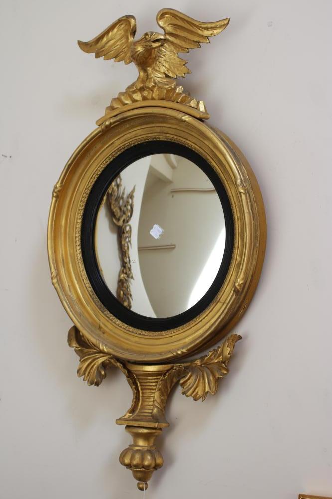 A GILT WOOD CONVEX MIRROR Image