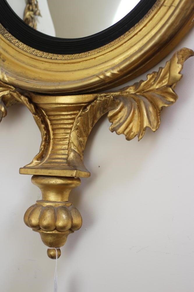 A GILT WOOD CONVEX MIRROR Image