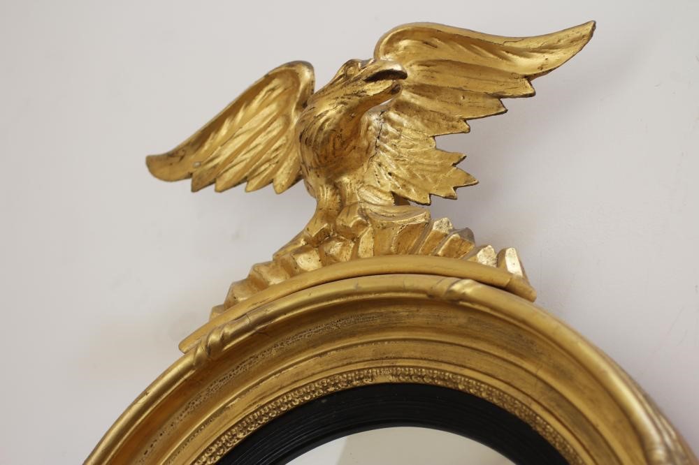 A GILT WOOD CONVEX MIRROR Image