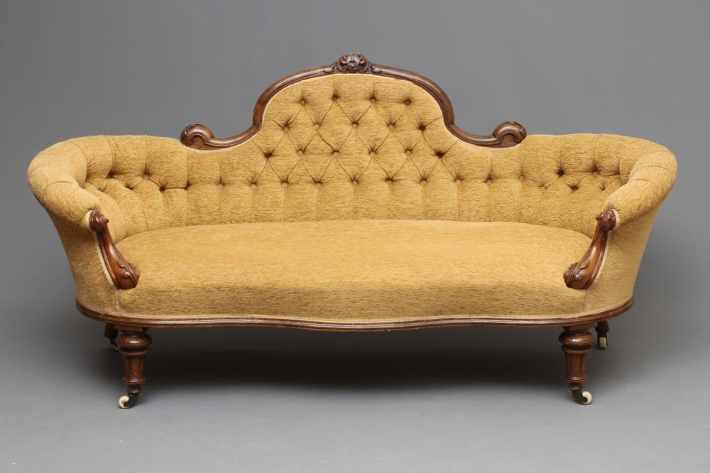 A VICTORIAN WALNUT SHOW FRAMED SOFA of serpentine form with rounded ends Image