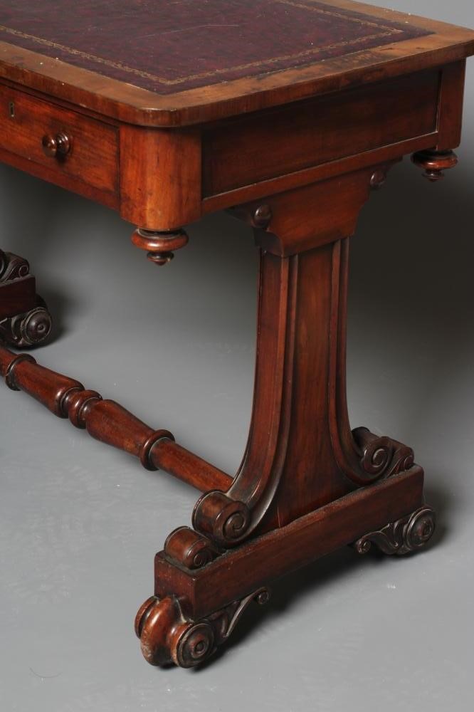 A VICTORIAN MAHOGANY WRITING TABLE of rounded oblong form inset with tooled red leather Image