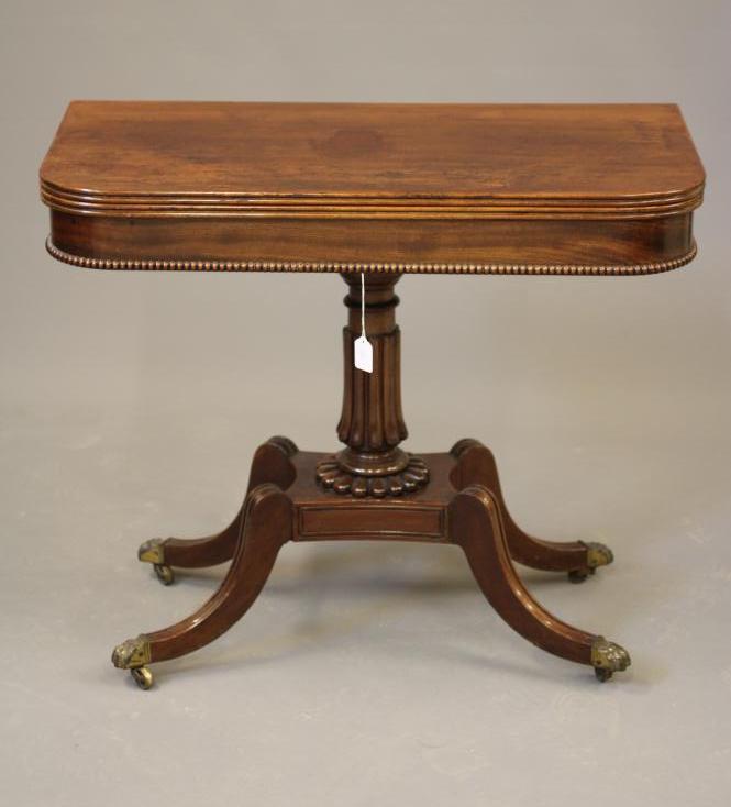 A REGENCY MAHOGANY FOLDING TEA TABLE of rounded oblong form Image