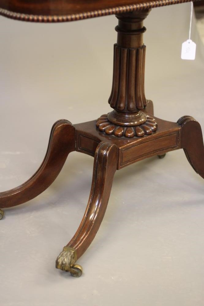 A REGENCY MAHOGANY FOLDING TEA TABLE of rounded oblong form Image