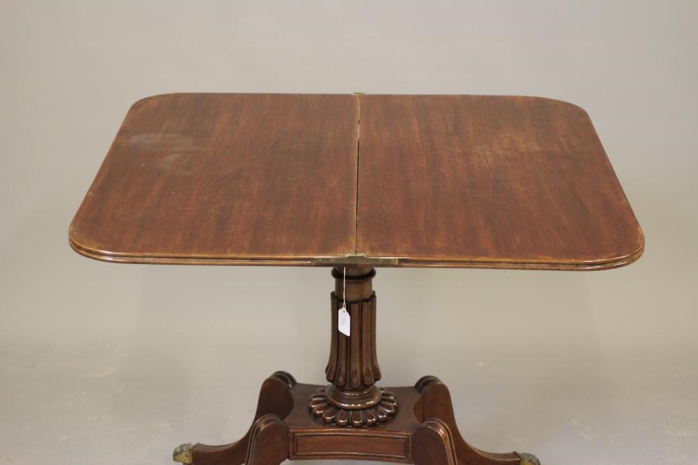 A REGENCY MAHOGANY FOLDING TEA TABLE of rounded oblong form Image