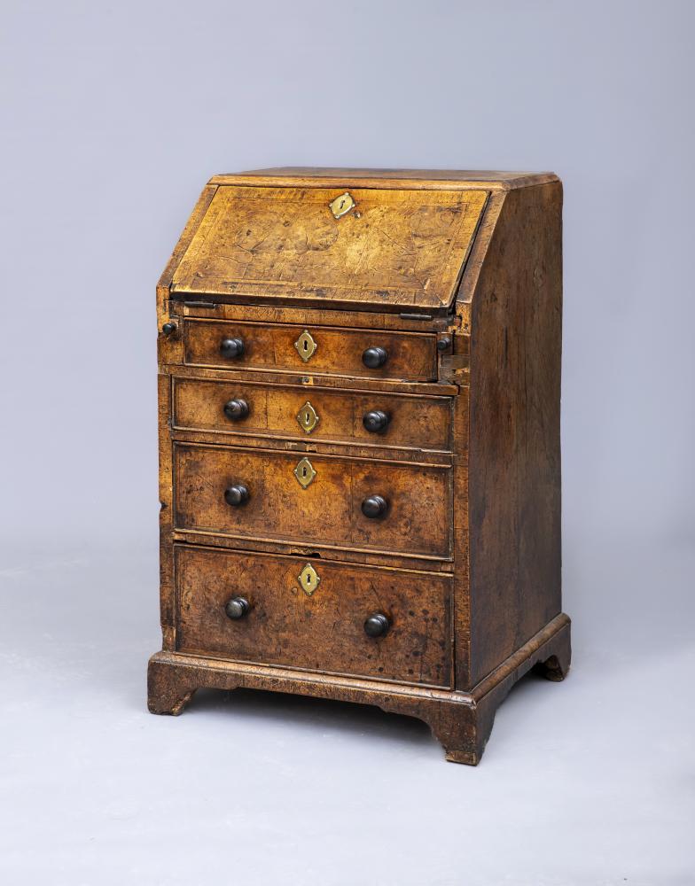 A WALNUT AND FEATHER BANDED BUREAU Image