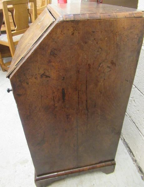 A WALNUT AND FEATHER BANDED BUREAU Image