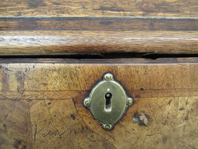 A WALNUT AND FEATHER BANDED BUREAU Image