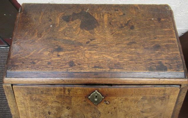 A WALNUT AND FEATHER BANDED BUREAU Image