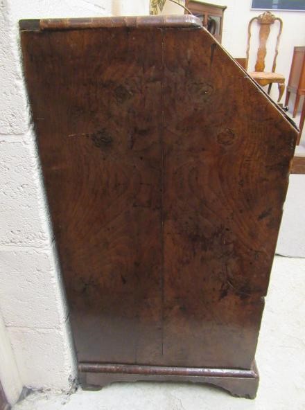 A WALNUT AND FEATHER BANDED BUREAU Image