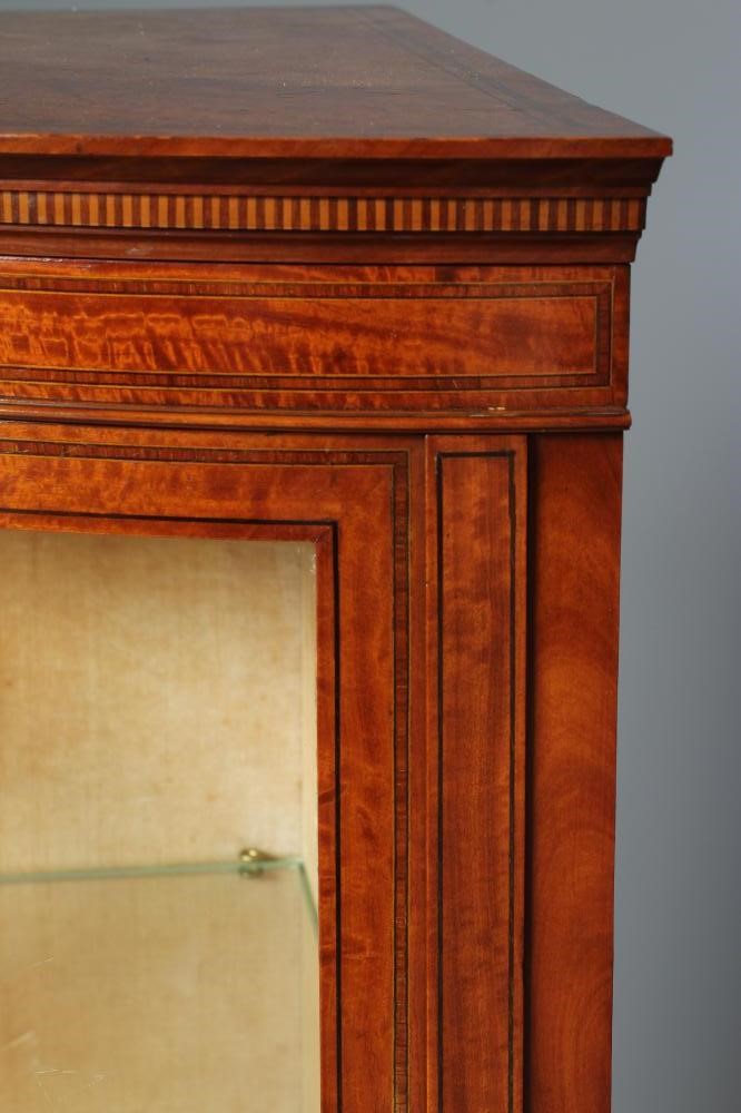 AN EDWARDIAN SATINWOOD SMALL CORNER CUPBOARD of concave form crossbanded with stringing Image