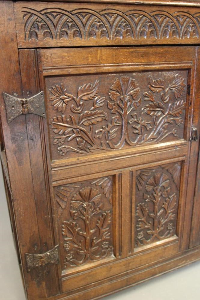 A CARVED JOINED OAK PRESS CUPBOARD Image