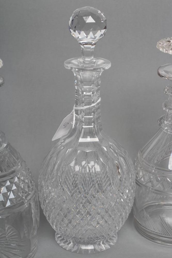 TWO VICTORIAN GLASS TRIPLE RING NECK MALLET DECANTERS AND STOPPERS with panelled shoulders and Image