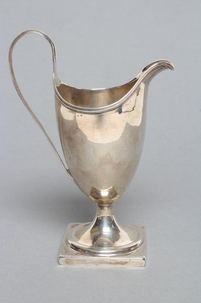 A GEORGE III PEDESTAL HELMET JUG Image