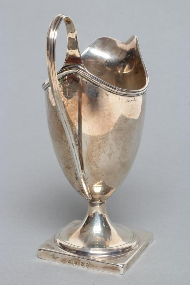 A GEORGE III PEDESTAL HELMET JUG Image