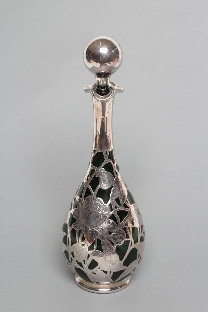 AN EDWARDIAN SILVER OVERLAY GREEN GLASS DECANTER Image