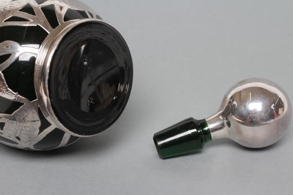 AN EDWARDIAN SILVER OVERLAY GREEN GLASS DECANTER Image