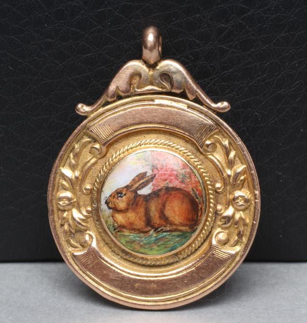 A 9CT GOLD FOB centred by a roundel enamelled with a rabbit Image