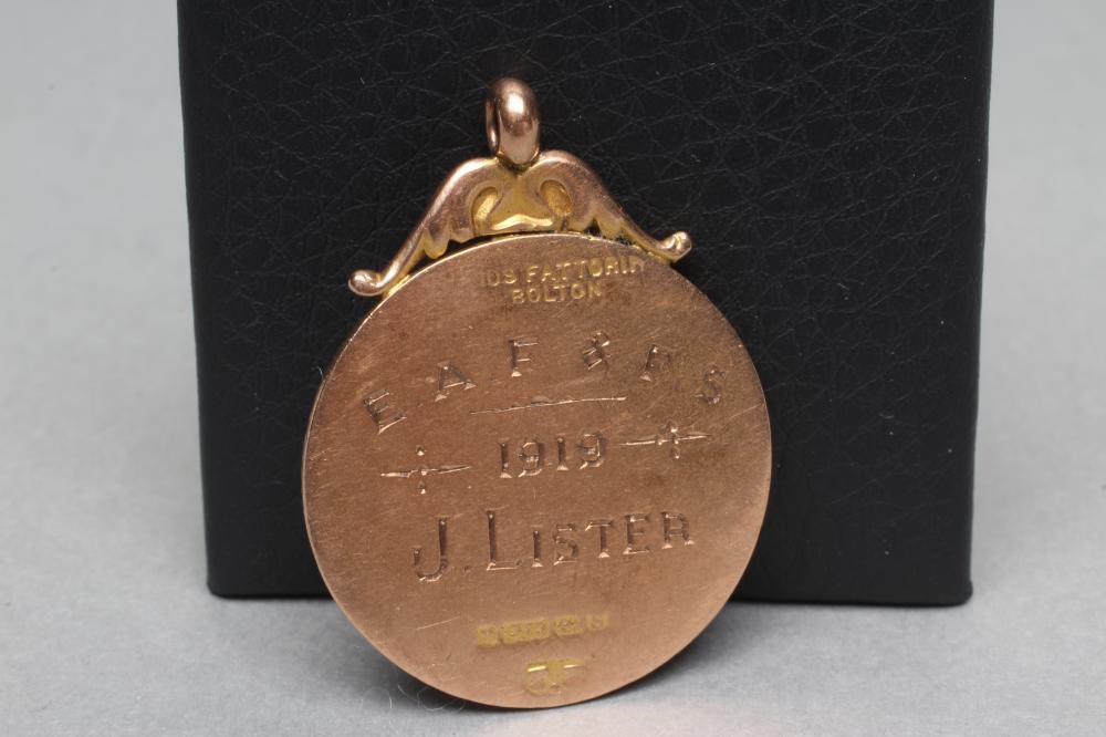 A 9CT GOLD FOB centred by a roundel enamelled with a rabbit Image