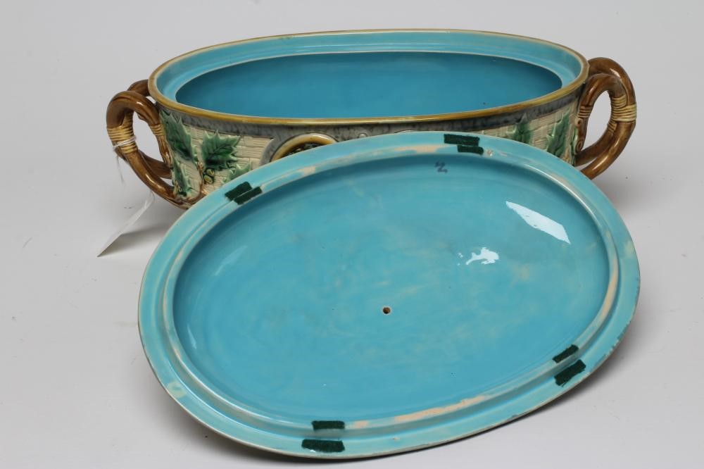 A VICTORIAN MINTON MAJOLICA GAME PIE DISH AND COVER of oval basket weave form with naturalistic Image