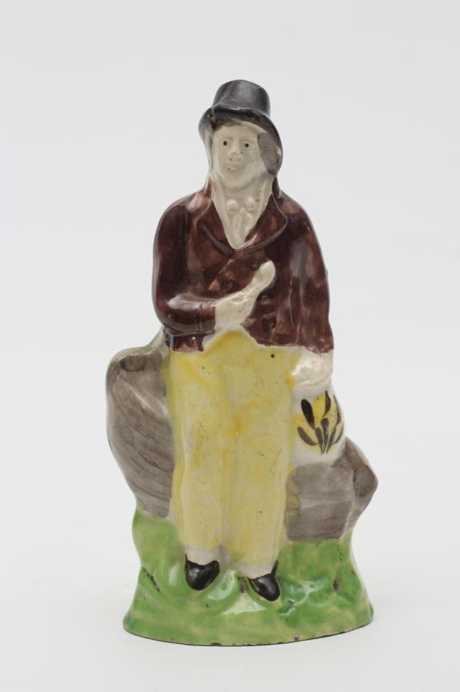 A CREAMWARE TOY FIGURE OF A SAILOR Image