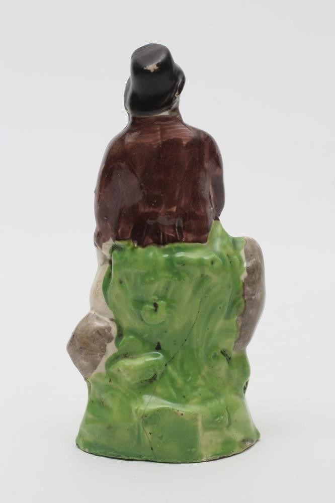 A CREAMWARE TOY FIGURE OF A SAILOR Image