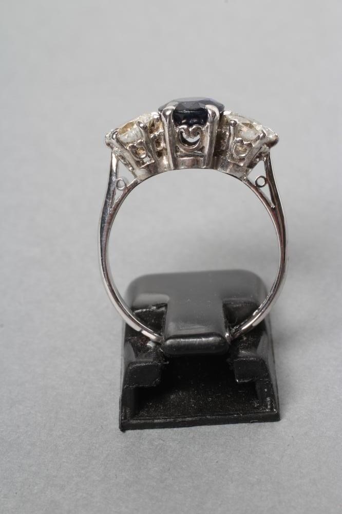 A SAPPHIRE AND DIAMOND THREE STONE RING Image