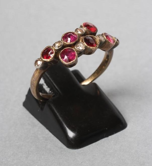 A VICTORIAN RUBY AND DIAMOND CROSSOVER RING collet set with six rubies and five rose cut diamonds to Image