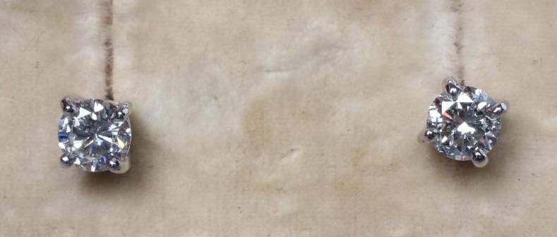 A PAIR OF SOLITAIRE DIAMOND EAR STUDS Image