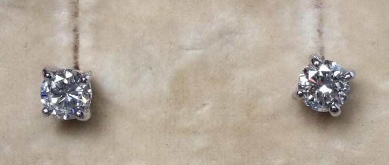 A PAIR OF SOLITAIRE DIAMOND EAR STUDS Image
