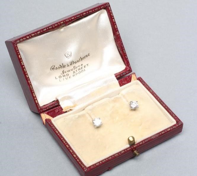 A PAIR OF SOLITAIRE DIAMOND EAR STUDS Image