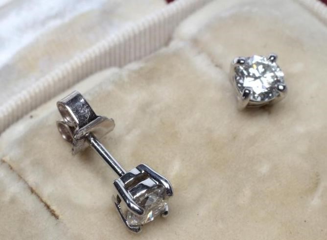 A PAIR OF SOLITAIRE DIAMOND EAR STUDS Image
