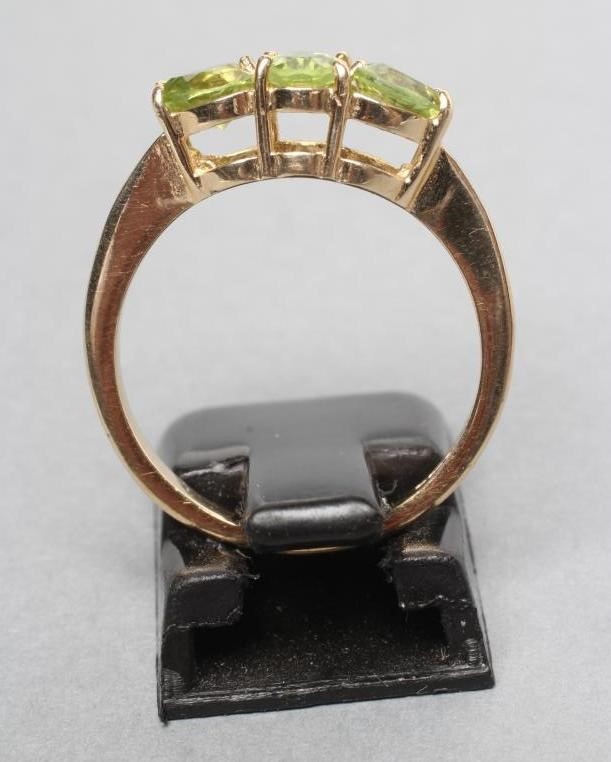 A THREE STONE PERIDOT RING Image