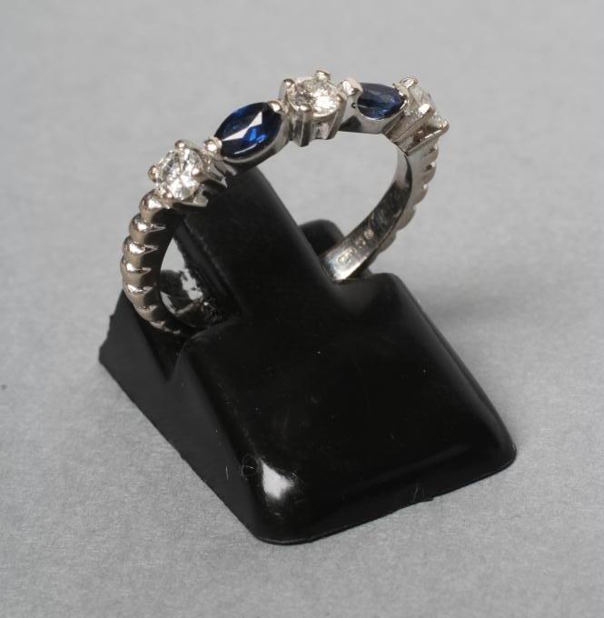 A SAPPHIRE AND DIAMOND HALF HOOP RING Image