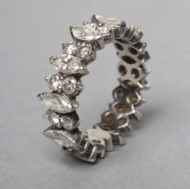 A DIAMOND ETERNITY RING claw set with eleven marquise cut stones Image