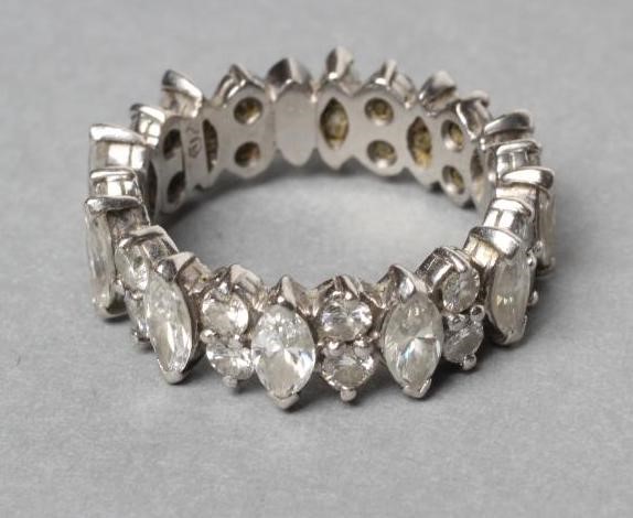 A DIAMOND ETERNITY RING claw set with eleven marquise cut stones Image