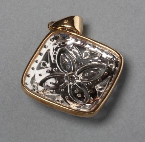 A DIAMOND PENDANT of quatrefoil form Image